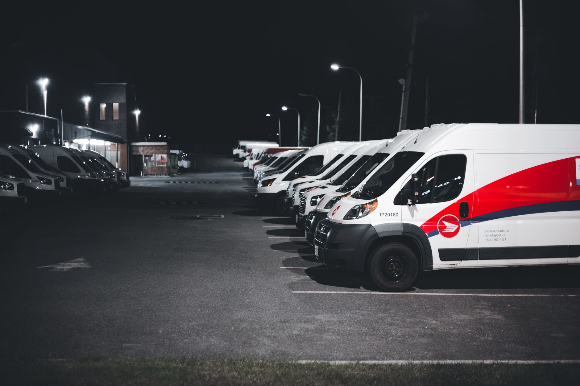A row of service vans at night