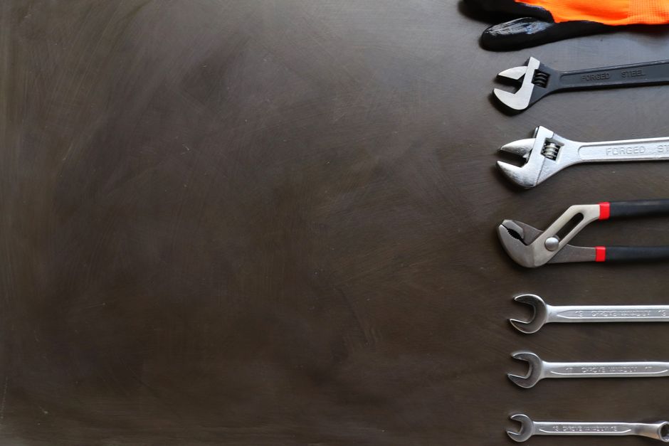 Wrenches on a dark bench