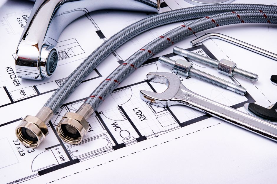 Plumbing tools on a blueprint